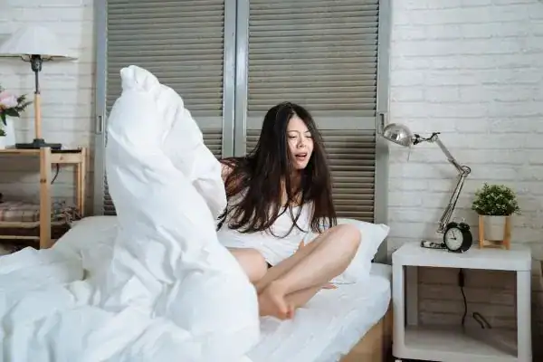 Image of woman getting up because of nighttime leaks Ipswich